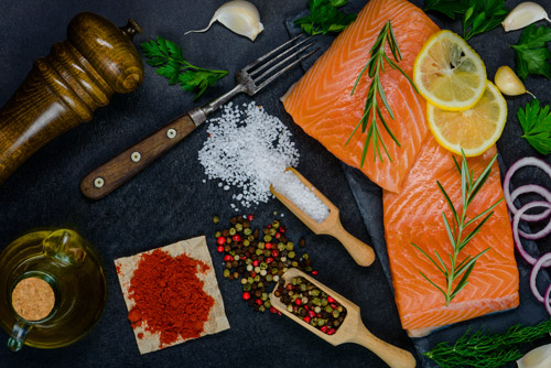 Salmon Fish Fillet with food seasoning, spices and cooking ingredients and herbs