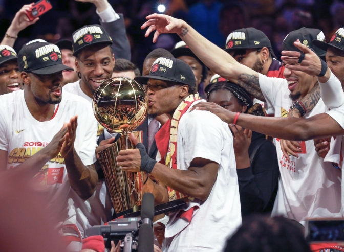 Toronto Raptors guard Kyle Lowry kisses the trophy